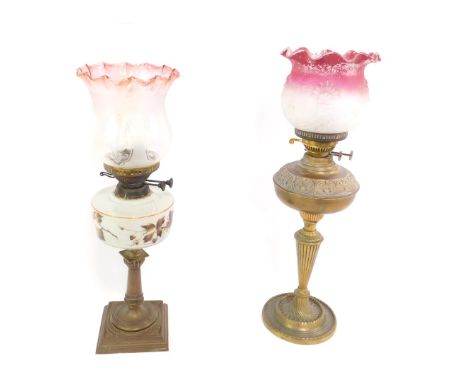 An Eltex brass oil lamp, with embossed and fluted decoration, with chimney and frosted and moulded shade, clear to red, 70.5c