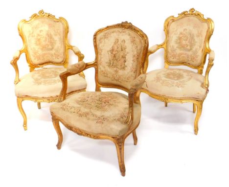 A pair of Victorian parcel gilt salon chairs, rococo style with tapestry overstuffed seat and back, raised on cabriole legs, 