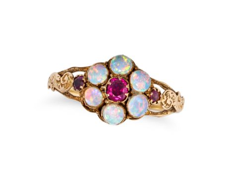 AN ANTIQUE OPAL AND RUBY CLUSTER RING in yellow gold, set with a cushion cut ruby in a cluster of cabochon opals, the shoulde