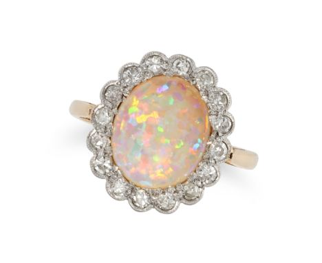 AN OPAL AND DIAMOND CLUSTER RING in yellow gold, set with an oval cabochon opal in a cluster of single cut diamonds, no assay