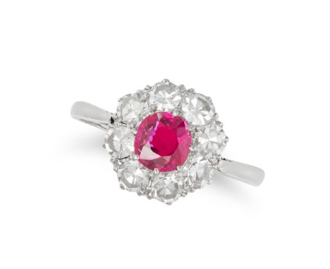 A RUBY AND DIAMOND CLUSTER RING in white gold, set with a ruby of approximately 0.60 carats in a cluster of single cut diamon