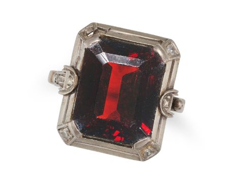 NO RESERVE - A GARNET AND DIAMOND RING in white gold, set with an octagonal step cut garnet, accented by round cut diamonds, 