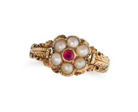 AN ANTIQUE RUBY AND PEARL RING in yellow gold, set with a round cut ruby in a cluster of seed pearls, no assay marks, size M1