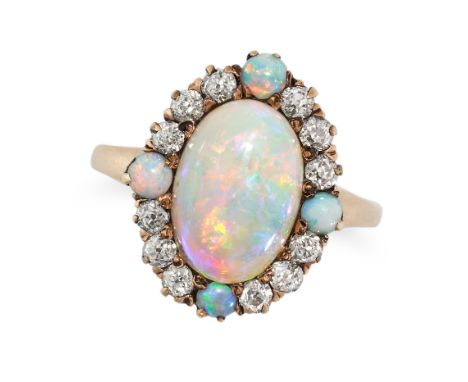 AN ANTIQUE OPAL AND DIAMOND RING in yellow gold, set with an oval cabochon opal in a border of old cut diamonds, accented by 