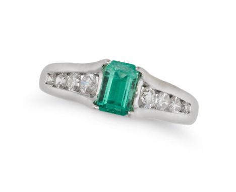 AN EMERALD AND DIAMOND RING in white gold, set with an octagonal step cut emerald of 0.64 carats, the shoulders set with roun