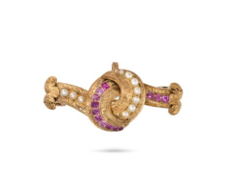 AN ANTIQUE RUBY AND PEARL BROOCH / PENDANT in yellow gold, designed as a stylised knot engraved with foliate detail, set with