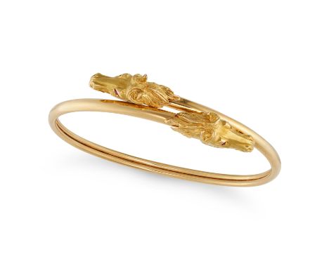 A VINTAGE RUBY HORSE BANGLE in 18ct yellow gold, designed as two coiled horses, the eyes set with round cut rubies, SS maker'