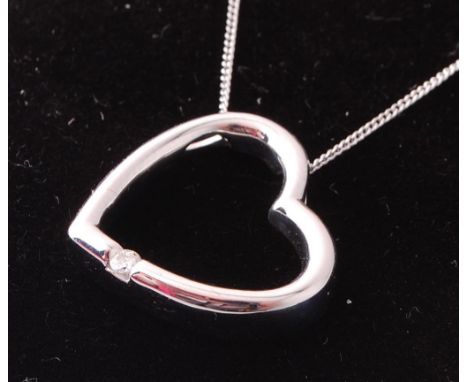 A 9ct white gold heart shaped pendant necklace set with a single round cut diamond. Set to a fine link back chain. Total weig