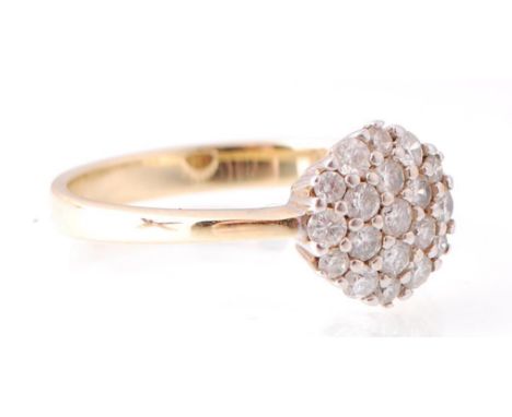 A 14ct yellow gold diamond pave set cluster ring. The roundel head adorned with diamonds on a basket setting. Total weight 2.