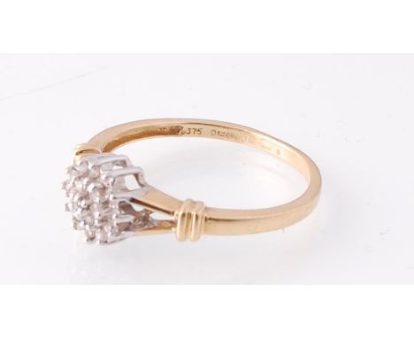 A 9ct gold London hallmarked diamond cluster ring&nbsp; set over pierced shoulders. Sponsors mark MJ. Total weight 1.74g / Si