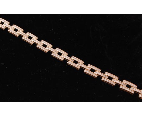 A 9ct gold and diamond tank link bracelet chain uniting with push clasp, each link being channel set with diamonds. Total wei