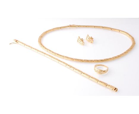 An 18ct gold&nbsp; / 750 marked suite of jewellery comprising a large necklace chain of Greek key design, matching bracelet c