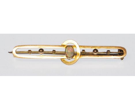 A late victorian / early 20th Century 9ct gold bar brooch having a double bar with central opal cabochon flanked by three gol