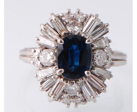 A hallmarked&nbsp; Art Deco style 18ct white gold sapphire and diamond ring. The ring set with a oval mixed cut sapphire surr