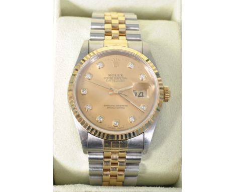 A gentleman's Rolex Datejust Oyster Perpetual two tone gold and stainless steel wristwatch having a round face with gilt dial