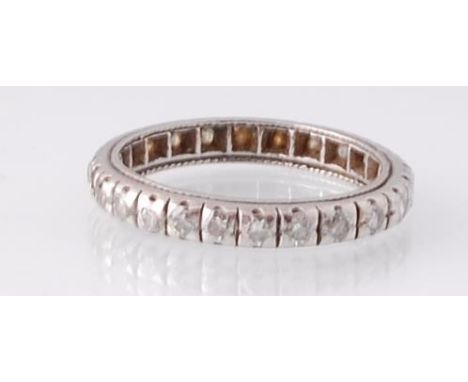 An 18ct white gold and diamond eternity ring. The white gold inset with round cut diamonds. Total weight 2.6g / Size J