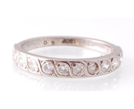 An 18ct white gold and diamond eternity ring. The channel set twelve diamonds in wave setting estimated dia weight 0.50pnts. 