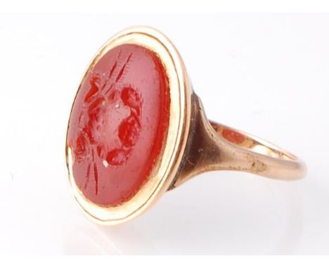 A 9ct gold and Carnelian ring. The carnelian intaglio seal in the form of a crab in bezel setting over plain shank. Total wei