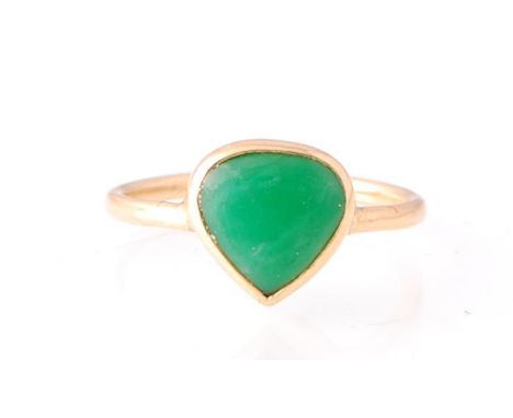 An 18ct gold and jade ring. The ring set with heart shaped green jade cabochon in a heart setting over plain shank. Unmarked,