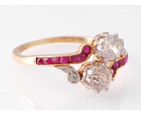 A 19th century ruby and diamond crossover ring. The ring having two old round cut diamonds united by channel set rubies with 