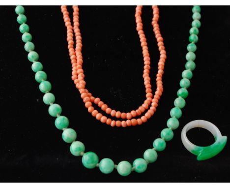 A coral bead necklace together with a jade necklace and a jade ring. The coral necklace strung with 2 - 3 mm beads, measures 