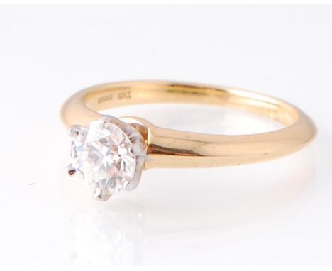 A hallmarked 18ct gold Tiffany &amp; Co diamond solitaire ring. The ring being set with a round brilliant cut diamond within 