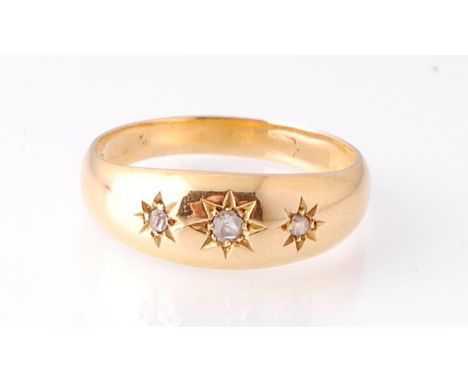A hallmarked Chester 18ct gold and diamond ring. The ring having a&nbsp; domed face with 3 star set round brilliant cut diamo