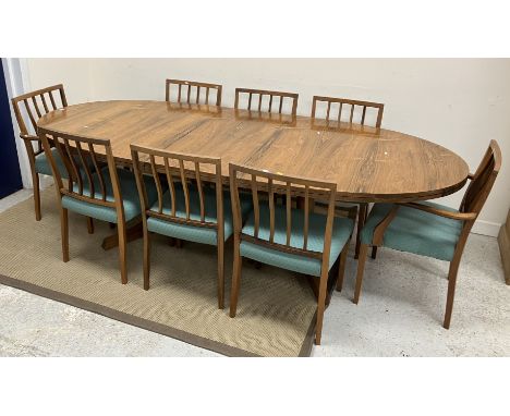 A Robert Heritage for Archie Shine (Heals) rosewood veneered D end dining table, on end pillar supports with centre leaf, 247