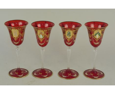 A set of four Victorian wine glasses with ruby red feet and bowl enamelled with floral swags, gilding and portraits raised on