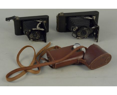 Two vintage Kodak bellow cameras plus a 'Orilux' London lamp in case