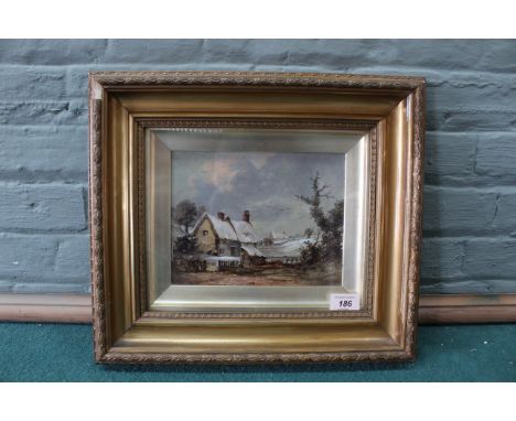 A late 19th Century framed oil on board of a country cottage in a winter landscape signed 'C M', 17cm x 22cm