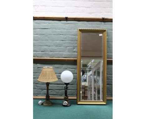 An Art Deco style table lamp with opaque globe, a brass Corinthian column table lamp plus a gilt wall mirror with bevelled gl