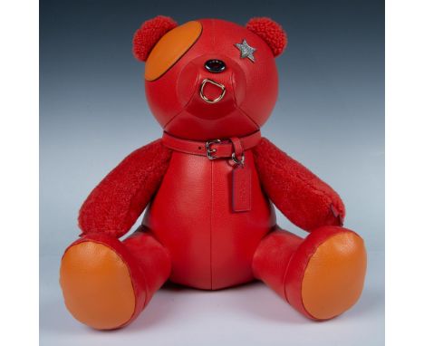This fabulous teddy bear with a leather body and plush arms, ears and tail is bright orange. His eye patch and the bottom of 