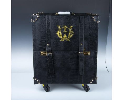 Luggage or storage finished with animal skin style. All black with gold toned metal hardware. Includes wheels and retractable