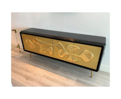 Organic Modernism. Jonathan Adler describes the piece as an ebonized and limed oak cabinet perched on solid brass legs and fe