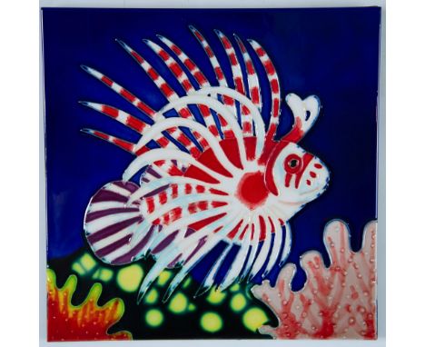 Large hand-painted decorative wall art ceramic tile of a colorful tropical Lionfish that swims by a bed of coral and bright y