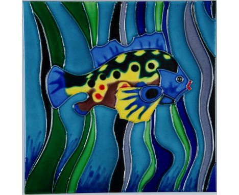 Large hand-painted decorative wall art ceramic tile of a colorful tropical fish that swims by waves and algae. Issued: c. 200