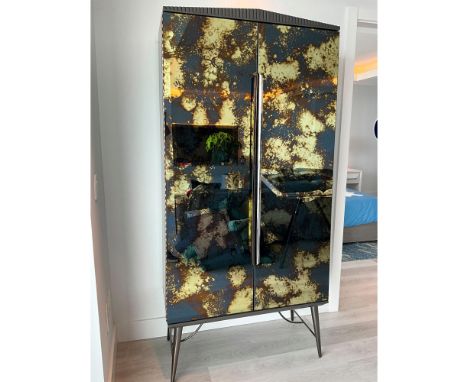 This bar cabinet mixes neoclassical elements with mid-century modern design for a collected over time aesthetic. Defined by V