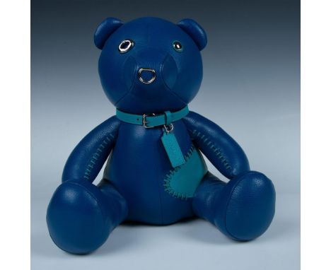 Fabulous blue bear named Ace is so cute. He has a teal blue whip stitched patch on his side. His arms have teal blue whip sti