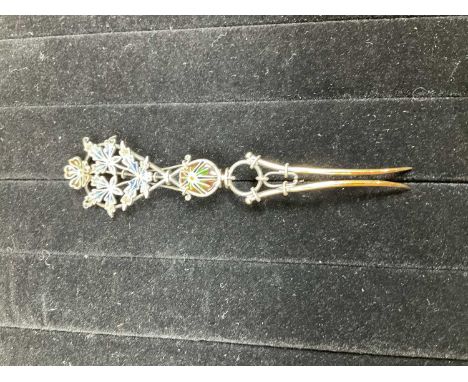 A white metal plique-à-jour enamel hair slide with foliate decoration, unmarked, length 12cm.