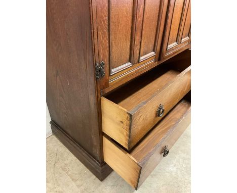 An oak tall boy, the cupboard with internal shelf with two drawers beneath, height 118cm, width 88cm, depth 48cm.