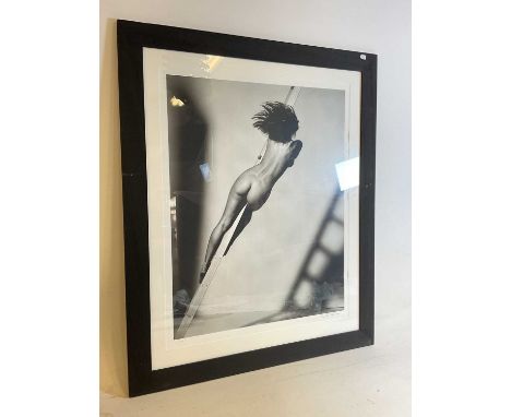 † JOHN SWANNELL; a limited edition black and white photographic print, female nude on ladder, signed, bearing blind stamp and