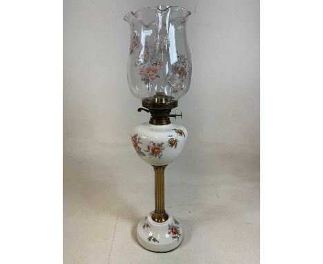 A ceramic oil lamp, with fluted pillar and decorated with roses. Total height 72cm
