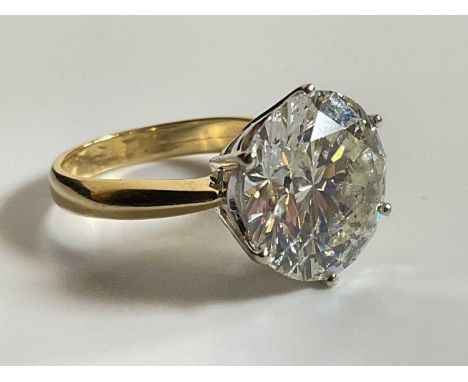 An impressive yellow metal diamond solitatire ring, the round brilliant cut stone approx. 7.40cts, in six claw setting, the s