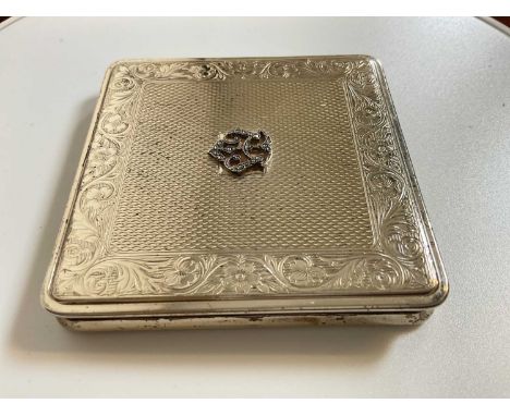 An Elizabeth II hallmarked silver compact with scroll engraved detail to the border, London 1953, 7 x 7cm.