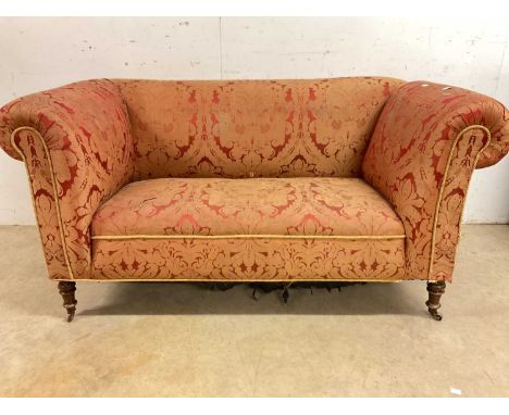 A late 19th/early 20th century small drop-end sofa on turned legs with small ceramic castors, height 75cm, width 150cm, depth