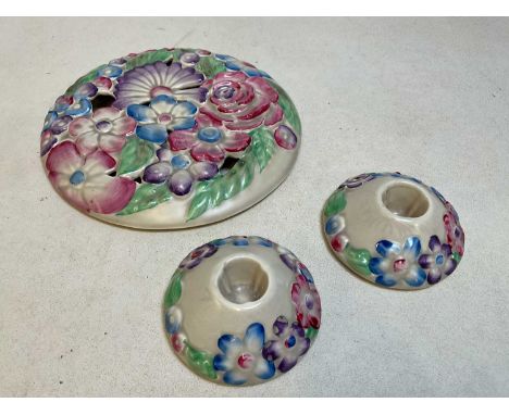 CLARIce CLIFF FOR WILKINSON; a wall plaque of circular form with moulded flowers in shades of pink, purple and blue, printed 