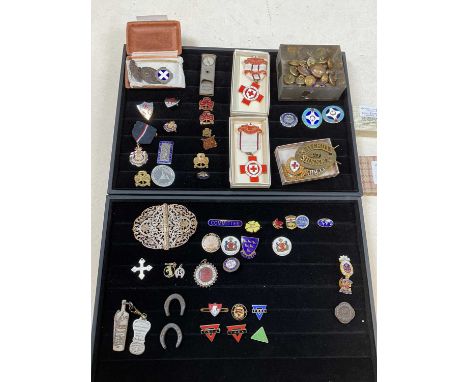 A large collection of enamel badges, including nursing badges, other enamel badges, and military buttons. 