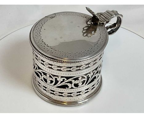 A George IV hallmarked silver drum mustard with raised thumb piece and blue glass liner, London 1820, diameter 6.7cm.Conditio