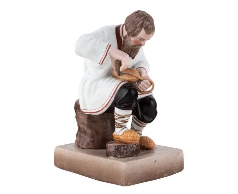 A RUSSIAN PORCELAIN FIGURE OF A BAST SHOE MAKER, GARDNER PORCELAIN FACTORY, MOSCOW, LATE 19TH CENTURY realistically modelled 